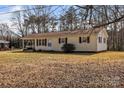 Cozy single-story home featuring light siding, brown shutters and a well-maintained yard at 115 Winterhaven Rd, Taylorsville, NC 28681