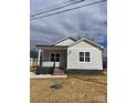 Newly built home features gray siding, a covered porch, and a landscaped yard at 1526 W Horah St, Salisbury, NC 28144