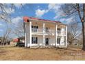 Two-story home with a red roof, double porches supported by columns, and dark shutters at 202 Deitz Rd, Statesville, NC 28625