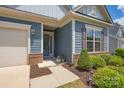Charming home entrance with a brick accented front, tidy landscaping, and a welcoming front door at 215 Pintail Dr, Monroe, NC 28110