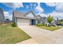 Inviting single Gathering home with a spacious driveway, well-maintained lawn, and attractive curb appeal at 215 Pintail Dr, Monroe, NC 28110