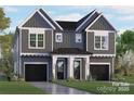 Charming two-story home with a modern gray exterior, black garage doors, and well-maintained landscaping at 2230 Revolution Park Dr, Charlotte, NC 28208