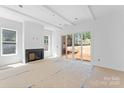 Bright living room with fireplace, recessed lighting, and sliding glass doors to backyard at 2230 Revolution Park Dr, Charlotte, NC 28208