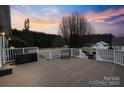 Spacious back deck with white railings and a large wooden surface perfect for outdoor entertaining at 2370 Old Mountain Rd, Statesville, NC 28625