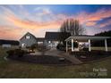 Lush backyard featuring a patio, gazebo, and a fire pit, ideal for relaxation and outdoor gatherings at 2370 Old Mountain Rd, Statesville, NC 28625