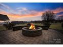 Inviting outdoor fire pit with stone surround, perfect for cozy evenings and social gatherings at 2370 Old Mountain Rd, Statesville, NC 28625