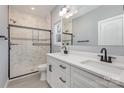Modern bathroom with double vanity, granite countertop, and tiled walk-in shower at 2385 Kool Park Ne Rd # 2, Hickory, NC 28601