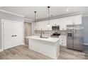 Modern kitchen with stainless steel appliances, a central island, and sleek white cabinetry at 2385 Kool Park Ne Rd # 2, Hickory, NC 28601
