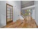 Elegant entryway with hardwood floors, staircase with iron railings, and lots of natural light at 2418 Lexington Approach Dr, Charlotte, NC 28262