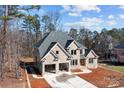 Aesthetic aerial view of a brick home with an attached two-car garage at 2418 Lexington Approach Dr, Charlotte, NC 28262