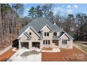 Beautiful brick home with an attached two-car garage and a driveway at 2418 Lexington Approach Dr, Charlotte, NC 28262