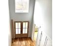 Bright foyer with double entry doors, hardwood floors, and a large window bringing in natural light at 2418 Lexington Approach Dr, Charlotte, NC 28262