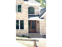 Close-up of the brick home's front door with glass panels and a stone walkway leading up to it at 2418 Lexington Approach Dr, Charlotte, NC 28262