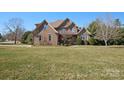 Stunning brick home featuring manicured landscaping and a spacious lawn at 2553 Cozy Cove Dr, York, SC 29745