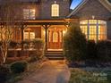 Elegant front entrance featuring a wood door with glass panels and a covered porch at 2553 Cozy Cove Dr, York, SC 29745