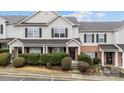 Inviting townhouse featuring a classic design, brick facade, manicured landscaping, and black shutters at 3553 Calpella Ct, Charlotte, NC 28262