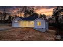 Charming one-story home featuring an attached garage and covered porch, set against a colorful sunset backdrop at 3722 Thompson St, Newton, NC 28658