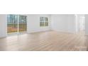 Bright living room featuring sliding glass doors to the deck, a large window, and modern flooring at 3722 Thompson St, Newton, NC 28658