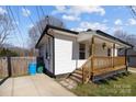 Side view of a cozy home with a charming covered porch and convenient off-street parking at 544 Baltimore Dr, Cramerton, NC 28032