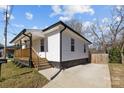 A cozy home featuring a covered porch, a spacious driveway and manicured yard at 544 Baltimore Dr, Cramerton, NC 28032