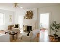 Bright living room featuring a fireplace, neutral furniture, and hardwood floors at 55 Academy Nw Ave, Concord, NC 28025