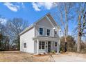 Charming two-story home with light gray siding, a covered front porch, and well-maintained landscaping at 709 N York St, Gastonia, NC 28052