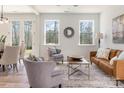 Bright living room featuring stylish seating, wood floors, and large windows with wooded views at 903 Cathey Rd, Charlotte, NC 28214