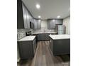 Modern kitchen with gray cabinets, quartz countertops, and stainless steel appliances at 9103 Exbury Ct, Charlotte, NC 28269