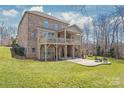 Expansive backyard with a two-story deck, a covered patio, and a lush green lawn at 9116 Arnsberg Dr, Waxhaw, NC 28173