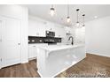 Modern kitchen features white cabinets, stainless steel appliances, and a large center island with pendant lighting at 110 Shay Crossing Rd # 1P, Salisbury, NC 28144