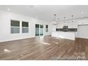 Bright open-concept living space with hardwood floors and sliding glass doors to the backyard at 110 Shay Crossing Rd # 1P, Salisbury, NC 28144