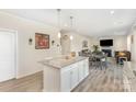 Elegant kitchen island with granite countertops connecting to the dining and living area at 1111 Fairbrae Ln, Indian Trail, NC 28079
