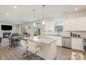 Open-concept kitchen with granite island, stainless appliances, and seamless flow to dining area at 1111 Fairbrae Ln, Indian Trail, NC 28079