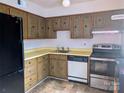 Functional kitchen area with laminate countertops, wooden cabinets and standard appliances at 115 Eastcliff Se Dr # 4, Concord, NC 28025