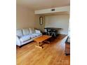 Open-concept living room featuring hardwood floors and minimalist furniture at 115 Eastcliff Se Dr # 4, Concord, NC 28025