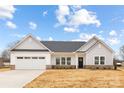 Charming single-story home with a two-car garage, a well-manicured lawn, and a welcoming front porch at 120 Random Dr, Salisbury, NC 28147