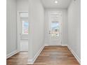 Bright entryway featuring a glass front door, hardwood floors, and view into a carpeted room at 1726 Riverbend Ave # 177, Belmont, NC 28012