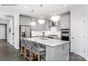 Modern kitchen features an island with barstool seating, stainless steel appliances, and pendant lighting at 1726 Riverbend Ave # 177, Belmont, NC 28012