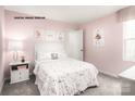 Cozy pink bedroom with comfortable decor and plenty of natural light at 320 Basildon St # 1076, Lancaster, SC 29720