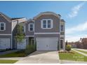 New townhome with a two-car garage, sidewalk, and fresh landscaping at 5030 Kellaher Pl, Charlotte, NC 28216