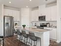 Modern kitchen features stainless steel appliances and a large island with seating at 5030 Kellaher Pl, Charlotte, NC 28216