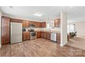 Modern kitchen boasts stainless steel appliances and sleek wooden flooring at 610 John St, Monroe, NC 28110