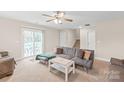 Inviting living room with a comfortable gray sofa and sliding door access at 610 John St, Monroe, NC 28110
