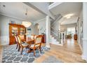 Open dining room featuring hardwood floors, a chandelier, and seamless access to the staircase at 658 Quicksilver Trl, Fort Mill, SC 29708