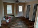Cozy living room with durable laminate flooring, neutral walls, and a ceiling fan, providing a comfortable space at 67 Travora Cir, York, SC 29745