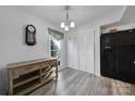Bright dining room with modern chandelier, wood floors, and ample storage at 6815 Cabot Cir, Charlotte, NC 28226
