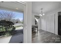 View from entryway showing dining area with modern lighting and storage at 6815 Cabot Cir, Charlotte, NC 28226