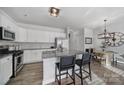 Well-equipped kitchen with granite countertops, stainless steel appliances, and a breakfast bar with seating at 116 Briana Marie Way, Indian Trail, NC 28079