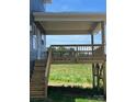 Features a covered deck with stairs leading to a grassy yard; ideal for outdoor living and entertaining at 1459 Mocksville Hwy # 19, Statesville, NC 28625