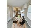 Dining area features a modern table set, new flooring, and neutral-colored walls at 1718 Fallston Rd, Shelby, NC 28150
